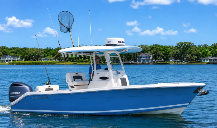 Westwind Waterman Cobia charter boat at rest on calm Gulf water with shoreline in the background